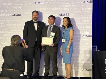 Dr. Wang receives his award on stage as he is inducted into AIMBE College of Fellows.
